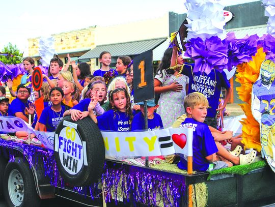 Colt Elementary float was filled with students cheering the Mustangs Sept. 9 at the Homecoming Parade on Main Street.
