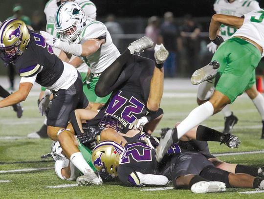 The Marble Falls Mustangs defense is about fighting through blocks and ensuring very few yards are gained thanks to the efforts of senior linebacker Brandon Guevara (9), junior defensive back Gregory Lemon (21) and senior defensive back Carter Hughes. Contributed photos by Martelle Luedeck...