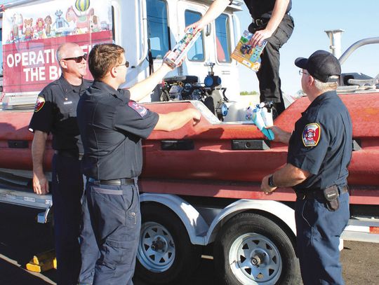 Granite Shoals Fire Department assists with collection of donated toys for the Christmas Outreach effort. Pictured, from left, are Lt. Joshua Nugent, Nick Mokry, Nick Ballard and Lt. David Short. Connie Swinney/The Highlander