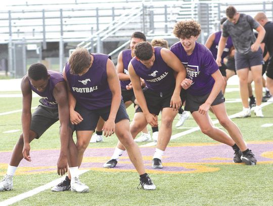 During Marble Falls Forge '24, the Mustangs pair up to undergo mat drills. One drill is to push against each other using their hips and sides, which brings amusement to Greg Lemon (front, left) and Brody Graham and Carson Parmer (back, left) and Brenton Liscum. Photos by Jennifer Fierro/Te...