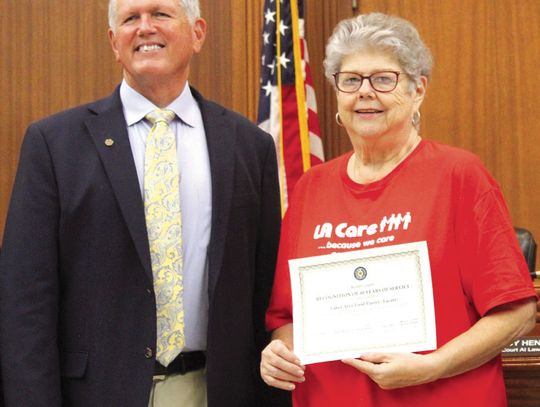 The Burnet County Commissioners Court recently congratulated the Lakes Area Food Pantry (LACare) for 40 years of service. LACare Executive Director Lottie McCorkle is pictured with Burnet County Judge Bryan Wilson. Raymond V. Whelan/Bulletin