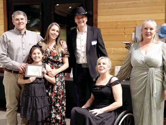 From left, Billy, Gracelynn (center) and Lindsey Yow of Spyke's BBQ received the Business of the Year Award from former recipients Gregg Miller, and Angie and Darla Godfrey of Reflections Day Spa &amp; Salon.