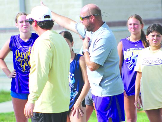 Marble Falls athletic director and football head coach Keri Timmerman (in the gray) meets with the Lady Mustangs before they go to different speed and agility stations. Photos by Jennifer Fierro/TexasChalkTalk.com