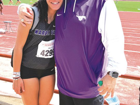 Sophomore Madison Cuplin and Mar- ble Falls track and field jumping coach Jamie Graham after the athlete sets a new personal best in the triple jump at the 97th annual Clyde Littlefield Texas Relays. Contributed photos