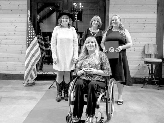 Pictured are Angie Godfrey, in front, and Darla Wilhite, back right, owners of Reflections Day Spa and Salon, who earned the Outstanding Business Award last year, presented by Melody Yanniell and Susan Patten, back left and middle. Contributed photos