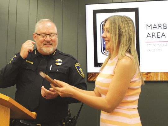 Marble Falls Police Chief Glenn Hanson presents the Marble Falls Police Civilian of the Year Award to Ashley Rodriguez during the city council meeting May 20. Raymond V. Whelan/The Highlander