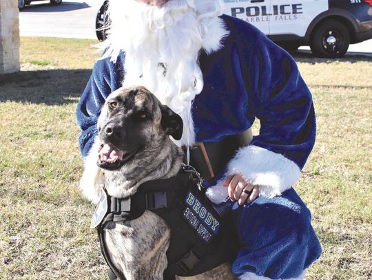 Blue Santa is pictured here with Marble Falls Police Department emotional support dog Brody. File photo