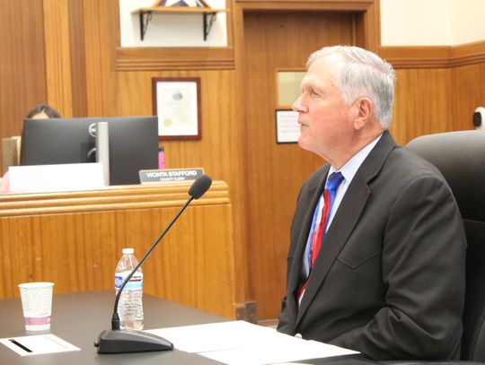 Former Texas grant manager and probation officer Bryan Wilson appears reflective as he responds to several question during the Burnet County Commissioners meeting Feb. 11. 