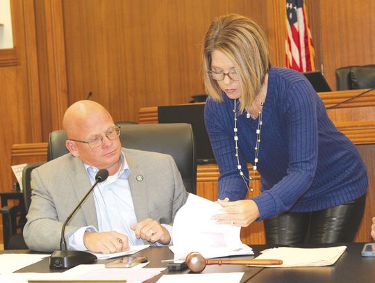 Burnet County Court Coordinator Stephanie McCormick assists Pct. 2 Commissioner Damon Beierle as he signs the first document of 2025 during the Burnet County Commissioners Court meeting Jan. 3 at the county courthouse. Raymond V. Whelan/The Highlander