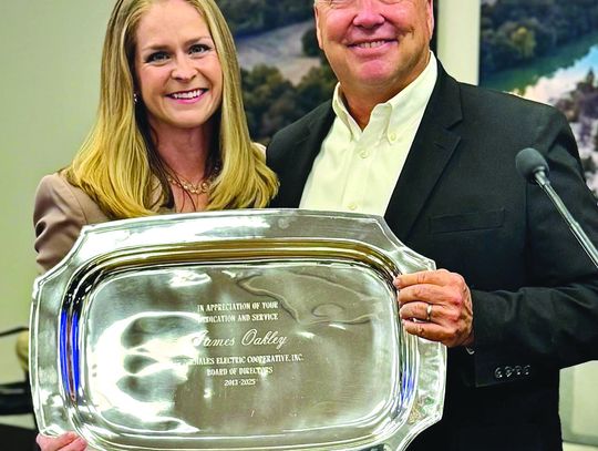 PEC president Emily Pataki presented outgoing District 5 Director James Oakley with an inscribed parting gift. Contributed photos
