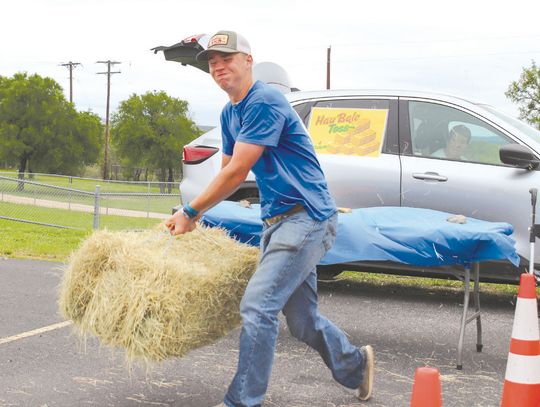 Alt Text forBrayson Hambrick demonstrated the hay bale toss game April 5, during the Marble Falls FFA Fest. Find more photos on Page 12. Photos by Martelle Luedecke/Luedecke Photography Image