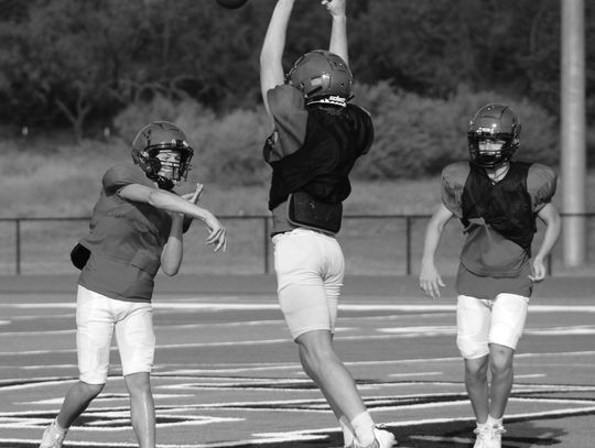 Faith Academy quarterback Madden Kinnee tries to make the pass through the outstretched arms of Adam Merlick. Photos by Jennifer Fierro/TexasChalkTalk.com