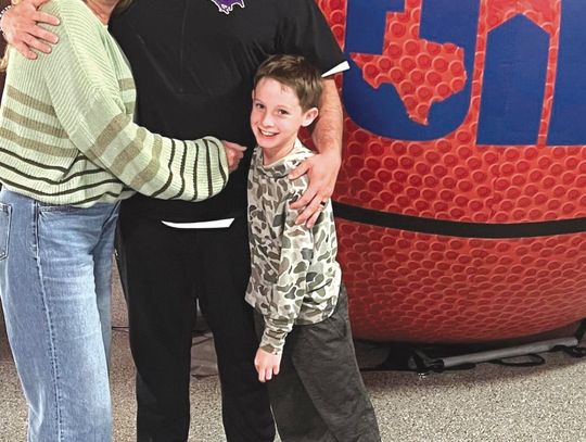 Sonny Wilson (center) is joining the Georgetown High School staff with the full support of wife Carrie and son Ryder. Contributed photo