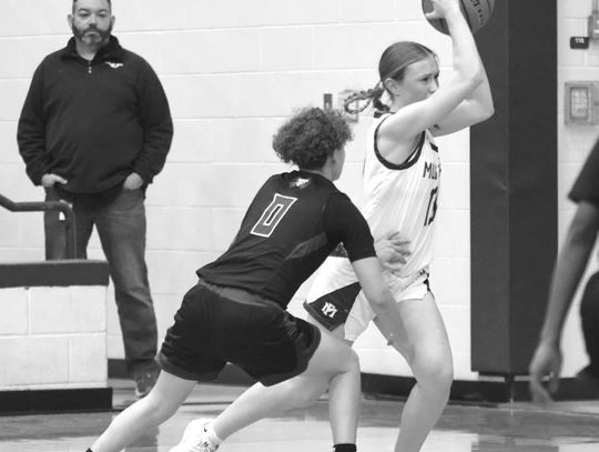 Marble Falls senior guard Kenadie Cotton is bumped as she prepares to pass the ball against Taylor.