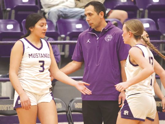 Marble Falls head coach Adley Canales (center) and the Lady Mustangs finish the first round of District 24-4A play.