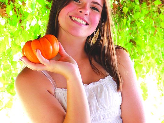 Grace Gates picks out the perfect pumpkin while at Sweet Berry Farm in Burnet County. Martelle Luedecke/Luedecke Photography