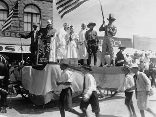 A patriotic parade float, captured in an area which is now Third Street and Main in Marble Falls, reveals its time period as riders hold an image of President Woodrow Wilson. Wilson was president of the United States from 1913 to 1921. Archives/Pictorial History of Marble Falls