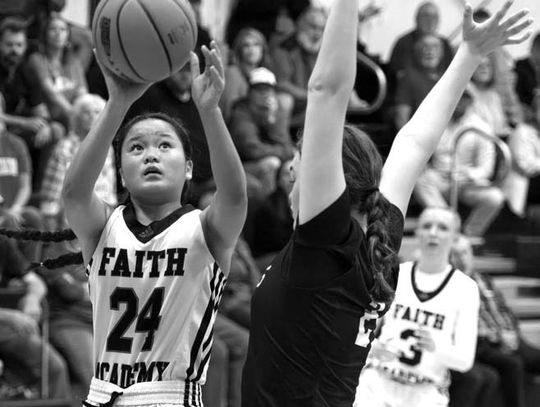 Faith Academy of Marble Falls fresh- man Jasmine Young doesn't allow a defender to sway her from shooting. Contributed photos/Stennis Shotts