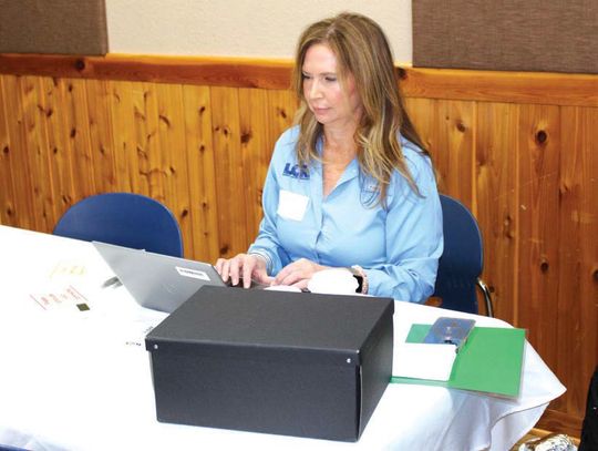 Lower Colorado River Authority Water Quality Supervisor Kelly Vinson prepares to receive local comments related to the proposed rock quarry near Hoover Valley Road. Raymond V. Whelan/The Highlander