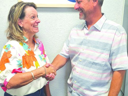 Kim Kankel, the new president/CEO of the Marble Falls/ Highland Lakes Area Chamber of Commerce, shook hands with Jarrod Metzgar, the outgoing president/ CEO of the area chamber. Contributed photo