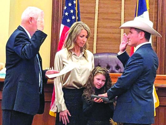 Llano County Judge Ron Cunningham (left) swore in Marquis Cantu Jan. 1 to assume the role as sheriff for the Llano County Sheriff's Department. His wife Sarah and their young daughter were also in attendance.