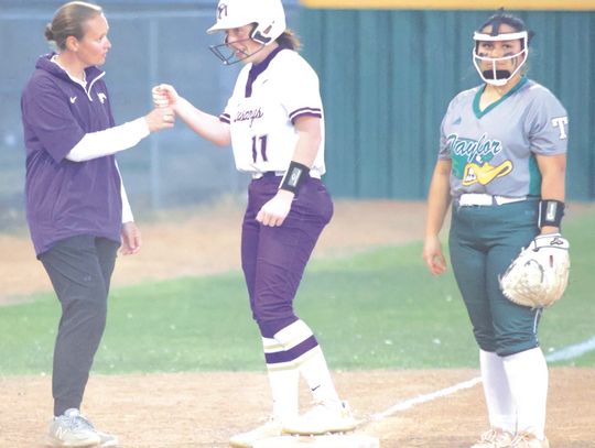 Assistant coach Hailey Wooten congratulates senior Sophia Biagini for a big hit that brought runners home against Taylor. Photos by Jennifer Fierro/TexasChalkTalk.com