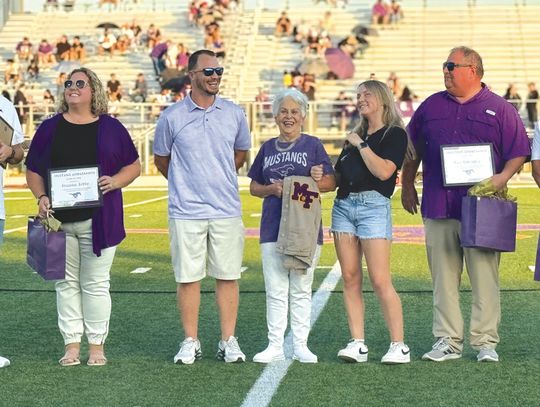 Contributed/ MFISD MFISD Superintendent Jeff Gasaway, at left, and Stan Whittle, at right, posed with Mustang ambassadors Jeanna Jette, Mary Ulbricht (with her grandchildren Charlie Ulbricht and Rylie Ulbricht) and Coy Guenter at the Homecoming game Sept. 20.