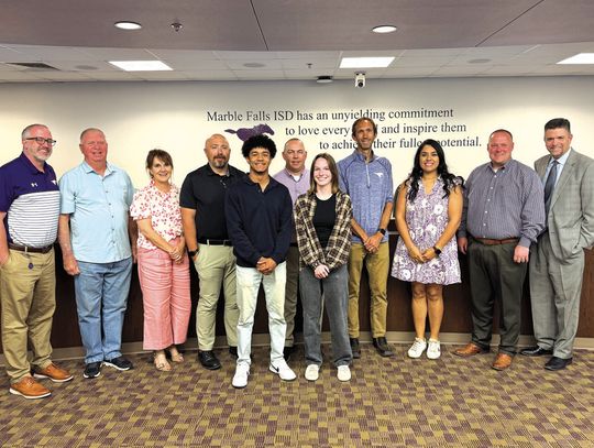 Two Superintendent's Awardees, student council president Isaiah Lazos and 2025 valedictorian Emma Cayce, accepted congratulations from school leaders behind them, from left, Principal Patrick Hinson, school board members Larry Berkman, Mandy McCary, Gary Boshears, Kevin Virdell, Alex Payso...