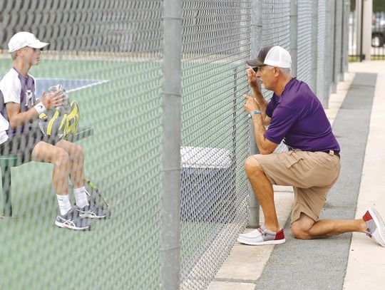 Marble Falls tennis head coach Samuel Whitley (right) talks to sophomore Cooper Womack before the start of the next game at the Class 4A state tournament.