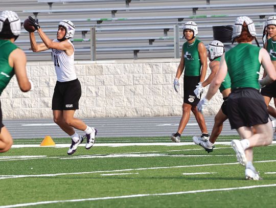 Marble Falls receiver Kaden Langbein catches a short pass before running for positive yards. Photos by Martelle Luedecke/Luedecke Photography