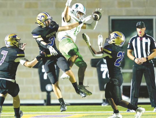 Marble Falls senior defensive back Jackson Trudeau (3) and junior defensive back Gregory Lemon (21) break up a pass intended for Burnet senior athlete Marcus Pimentel as junior linebacker Doak Timmerman (7) prepares to assist.