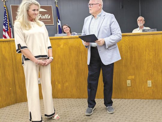Marble Falls Mayor Dave Rhodes gives Kim Edwards the proclamation honoring Rick Edwards, her late husband, former Marble Falls ISD board member and beloved community benefactor. The Day of Service in his honor is scheduled for Feb. 14, when volunteers will descend on the community for phil...
