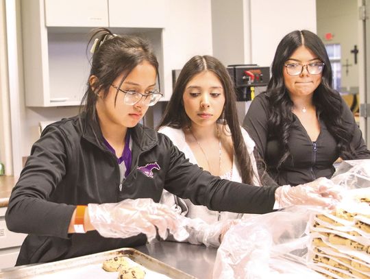 From left, Bri Avalos, Sharon Estrada and Nainna Flores baked cookies Feb. 14 at First Methodist Church in Marble Falls for Rick Edwards Day of Service. Photos by Martelle Luedecke/Luedecke Photography
