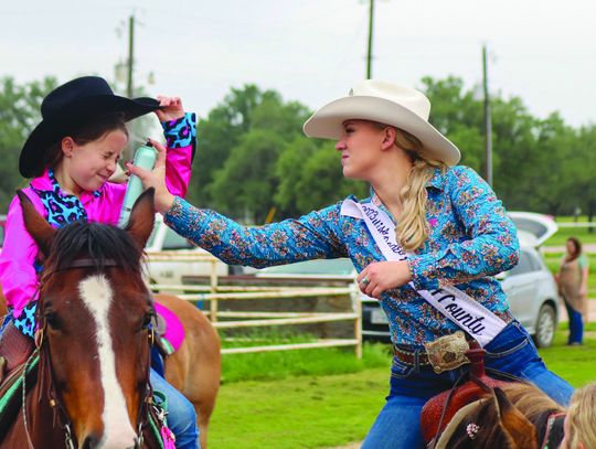 Jade Simon raised her hat for Trinity Frazier to apply more hairspray to keep her hat from flying off Saturday, May 4, at the Burnet County Rodeo Association 2024 Scholarship Pageant. See more photos on Page 14. Martelle Luedecke/Luedecke Photography