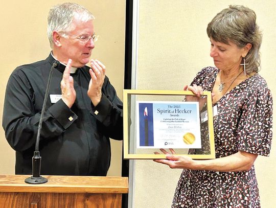 St. Paul's Pastor Fr. Brad Schoeberle, C.S.P., presented the 2025 Hecker Award for service to her parish and community to longtime St. Paul's parishioner and