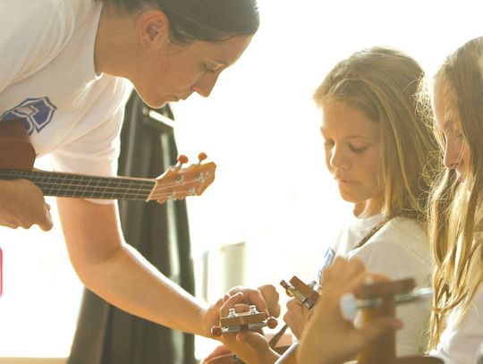 Kerry West, music teacher at Spicewood Christian Academy, instructs Adilyn Smiles, along with, from left, Chloe Chorn and Audrey Magno this semester during guitar lessons in class. The campus, started in 2021, serves kindergar - ten through 12th grade. Find a feature in the Tuesday, Feb. 4...