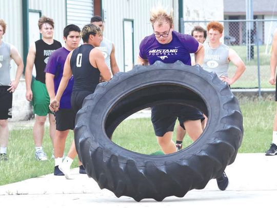 Part of what makes the Marble Falls ISD's athletic department's approach to getting stronger, faster and more agile is how strength-and-conditioning coordinator Karl 'Beef' Bielfeldt uses other disciplines to help his athletes, including Tyler Leverett, who is flipping a tire. Photos by Je...