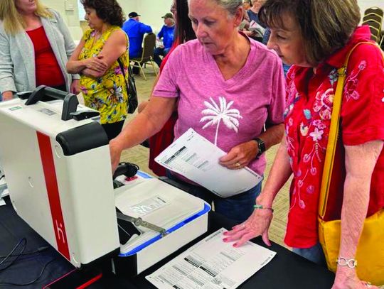 In June last year, residents Londa Chandler (left) and Darlene Hargett took a closer look at the planned new voting devices for Burnet County. The public gets an - other look on Feb. 25. File photo