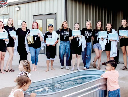 Photos by Martelle Luedecke/ Luedecke Photography After their baptism through Young-Lives at Hill Country Fellowship, participants draped in towels posed with their bibles and certificates March 24.