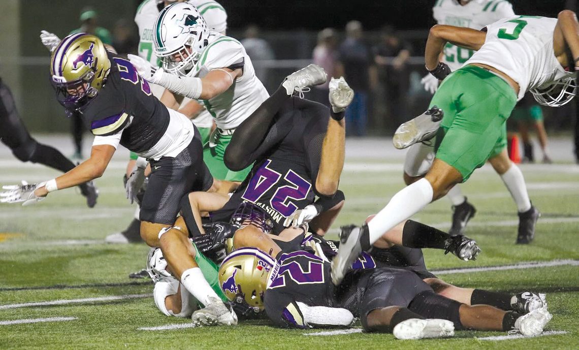 The Marble Falls Mustangs defense is about fighting through blocks and ensuring very few yards are gained thanks to the efforts of senior linebacker Brandon Guevara (9), junior defensive back Gregory Lemon (21) and senior defensive back Carter Hughes. Contributed photos by Martelle Luedeck...