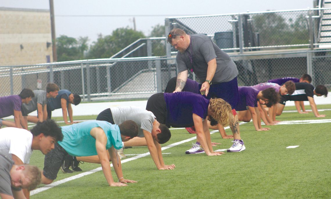 Photos by Jennifer Fierro/TexasChalk- Talk.com On first day of Marble Falls Forge '24, coaches emphasis the proper way to do each drill as illustrated by Marble Falls strength and con- ditioning coordina - tor Karl "Beef" Bielfeldt, who is helping Deagan Whitted.