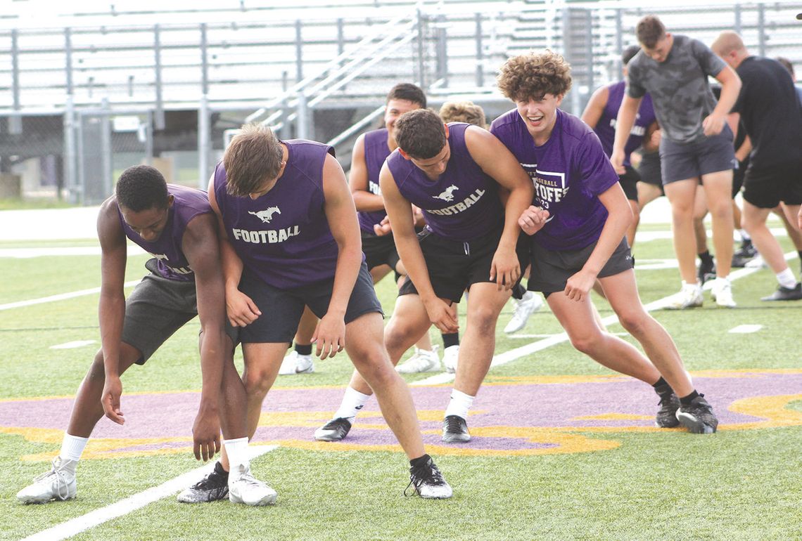During Marble Falls Forge '24, the Mustangs pair up to undergo mat drills. One drill is to push against each other using their hips and sides, which brings amusement to Greg Lemon (front, left) and Brody Graham and Carson Parmer (back, left) and Brenton Liscum. Photos by Jennifer Fierro/Te...