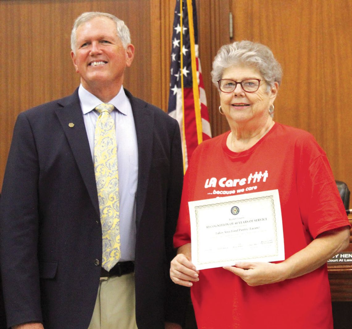 The Burnet County Commissioners Court recently congratulated the Lakes Area Food Pantry (LACare) for 40 years of service. LACare Executive Director Lottie McCorkle is pictured with Burnet County Judge Bryan Wilson. Raymond V. Whelan/Bulletin