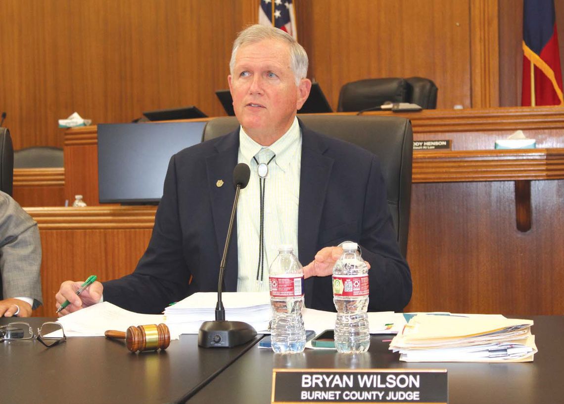 Burnet County Judge Bryan Wilson, pictured here reciting a resolution to oppose a rock quarry in Hoover's Valley, presided over the May 13 meeting. Raymond V. Whelan/The Highlander