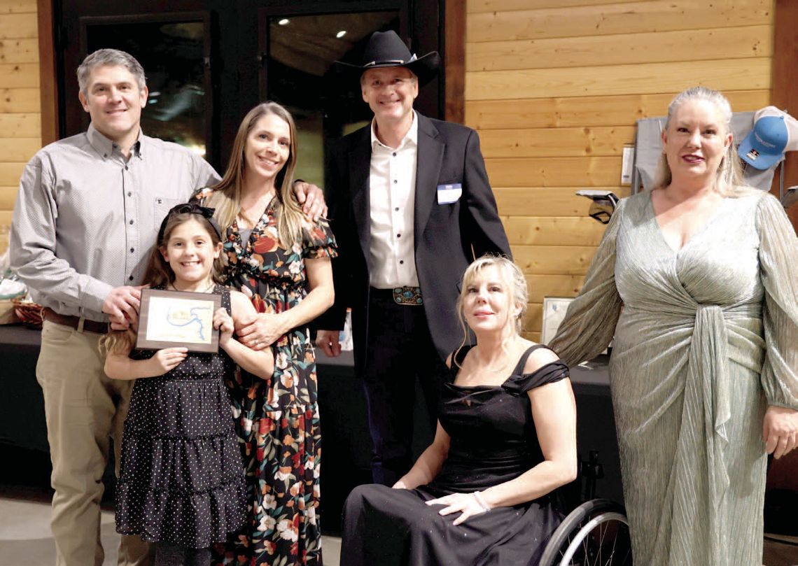 From left, Billy, Gracelynn (center) and Lindsey Yow of Spyke's BBQ received the Business of the Year Award from former recipients Gregg Miller, and Angie and Darla Godfrey of Reflections Day Spa &amp; Salon.