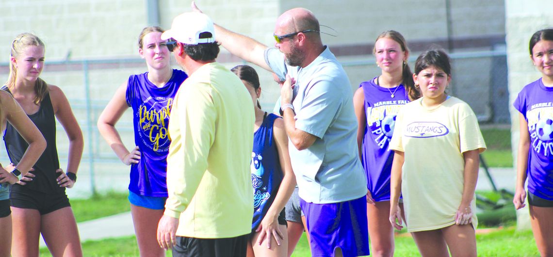 Marble Falls athletic director and football head coach Keri Timmerman (in the gray) meets with the Lady Mustangs before they go to different speed and agility stations. Photos by Jennifer Fierro/TexasChalkTalk.com