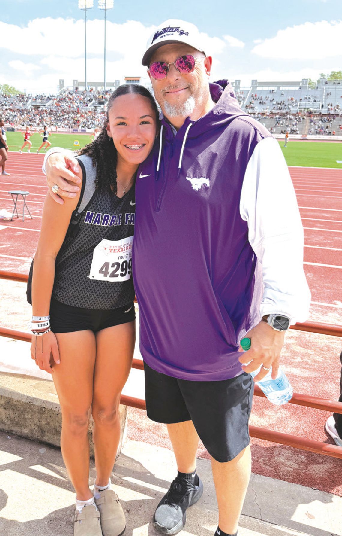 Sophomore Madison Cuplin and Mar- ble Falls track and field jumping coach Jamie Graham after the athlete sets a new personal best in the triple jump at the 97th annual Clyde Littlefield Texas Relays. Contributed photos