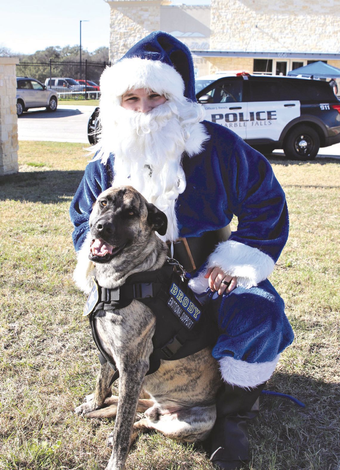 Blue Santa is pictured here with Marble Falls Police Department emotional support dog Brody. File photo