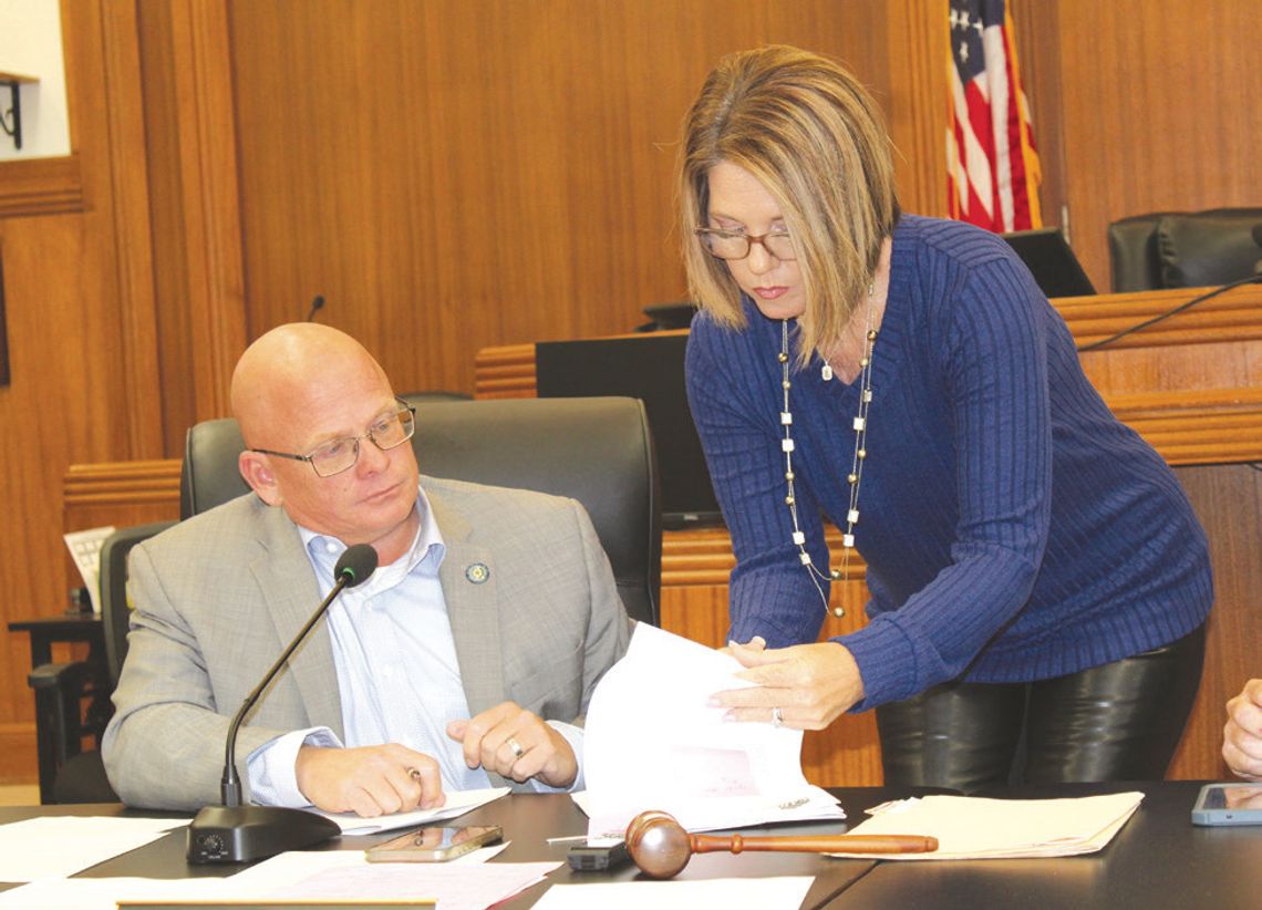 Burnet County Court Coordinator Stephanie McCormick assists Pct. 2 Commissioner Damon Beierle as he signs the first document of 2025 during the Burnet County Commissioners Court meeting Jan. 3 at the county courthouse. Raymond V. Whelan/The Highlander