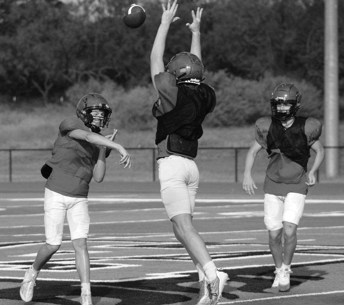 Faith Academy quarterback Madden Kinnee tries to make the pass through the outstretched arms of Adam Merlick. Photos by Jennifer Fierro/TexasChalkTalk.com